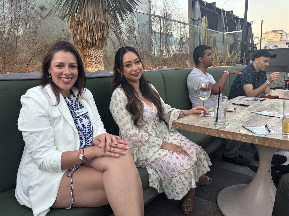 Guests mingling at a golden hour rooftop social